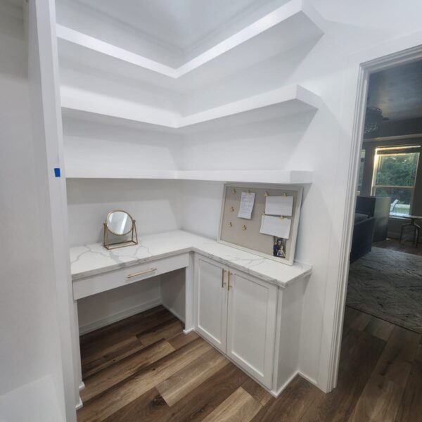The Woodlands Premier Remodeling after photo of primary closet with makeup desk space and custom cabinetry